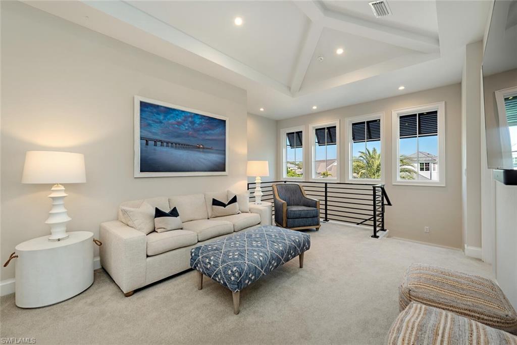 16715 Enclave Circle Naples, FL 34110 - Photo 23 of 33 a living room with furniture a lamp and a window