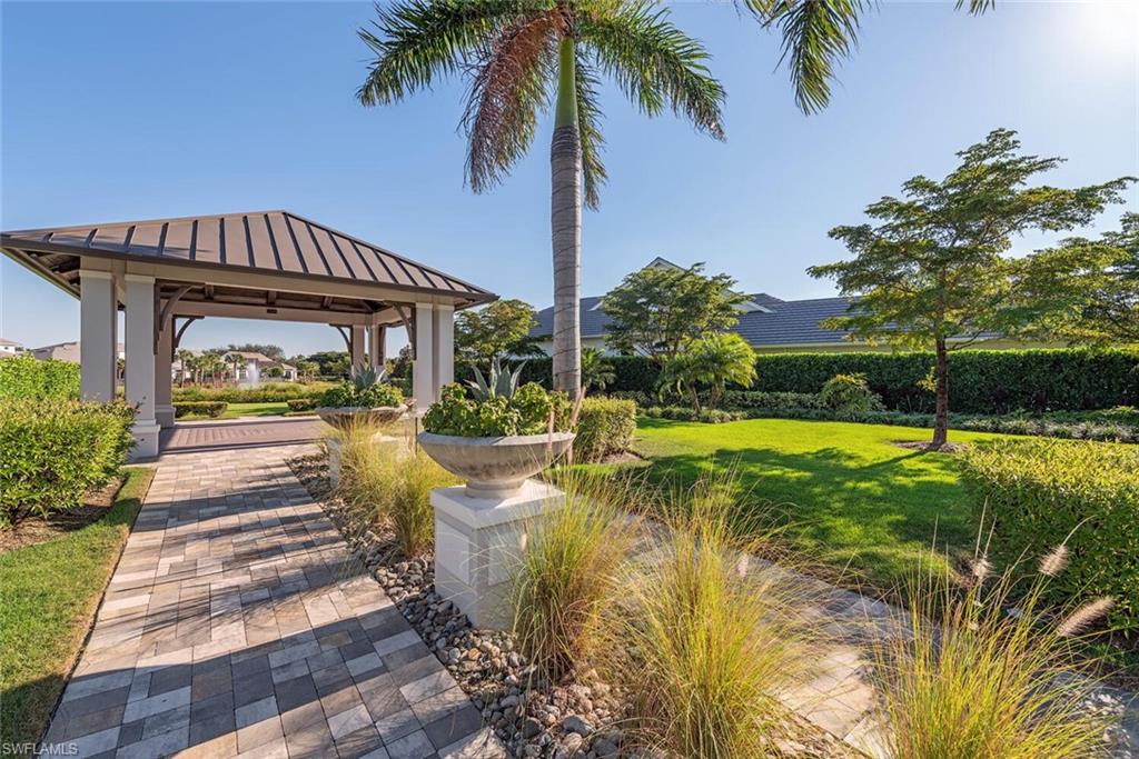 16715 Enclave Circle Naples, FL 34110 - Photo 33 of 33 a view of swimming pool with lawn chairs and plants