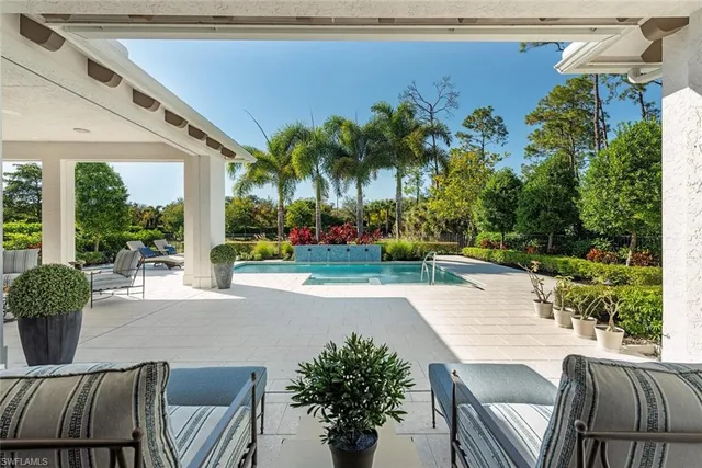 a view of a patio with a table and chairs and potted plants