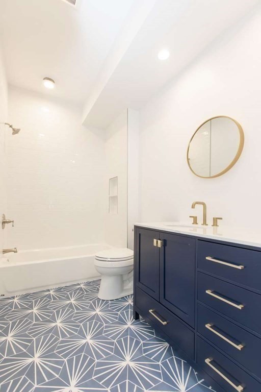 9 Wompatuck Road Hingham, MA 02043 - Photo 4 of 24 a bathroom with a granite countertop toilet a sink and a mirror