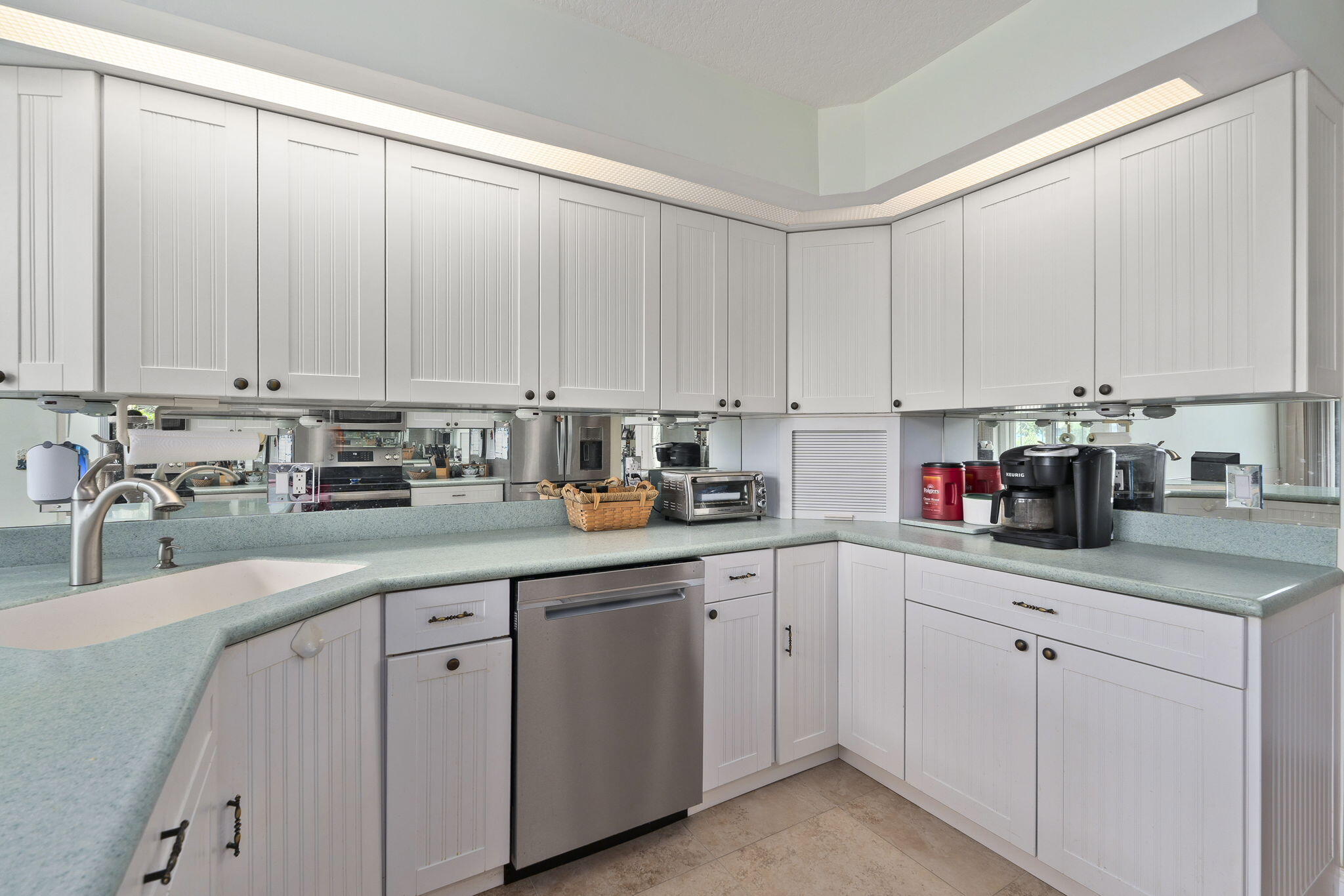 8964 Southeast Sunfish Place Hobe Sound, FL 33455 - Photo 20 of 51 a kitchen with cabinets appliances a sink and a window