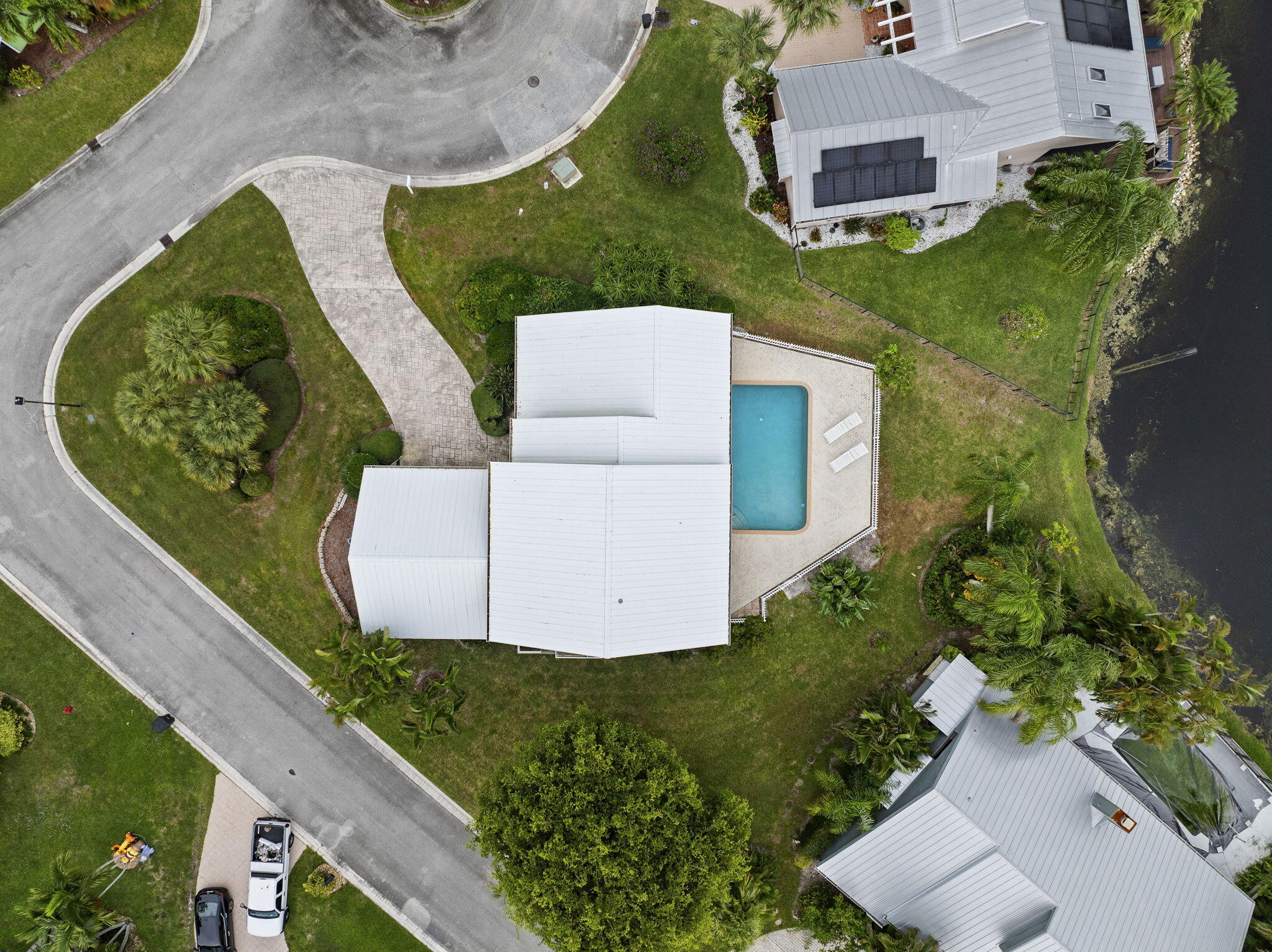 8964 Southeast Sunfish Place Hobe Sound, FL 33455 - Photo 2 of 51 an aerial view of a house having yard