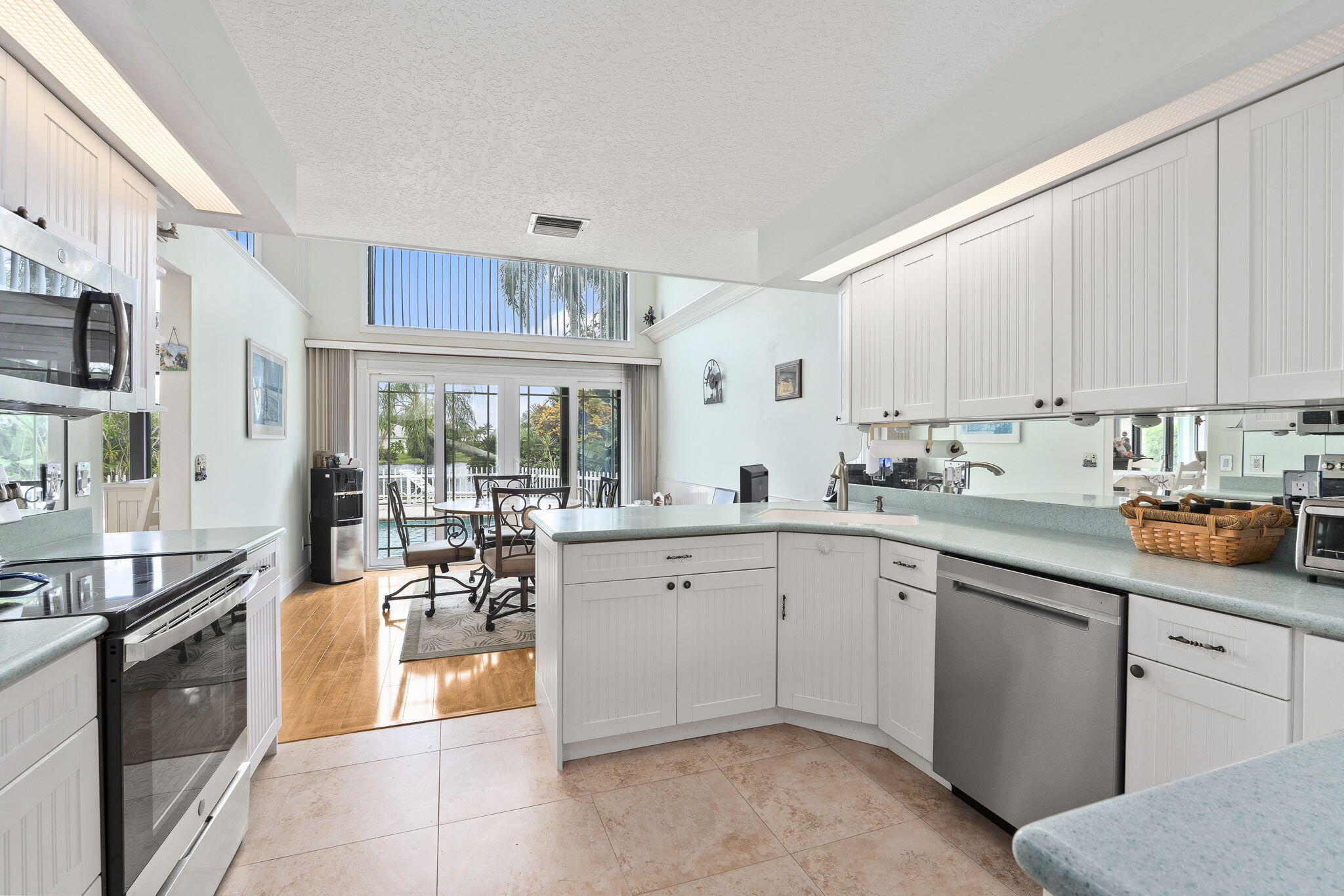 8964 Southeast Sunfish Place Hobe Sound, FL 33455 - Photo 21 of 51 a kitchen with a sink stove and cabinets