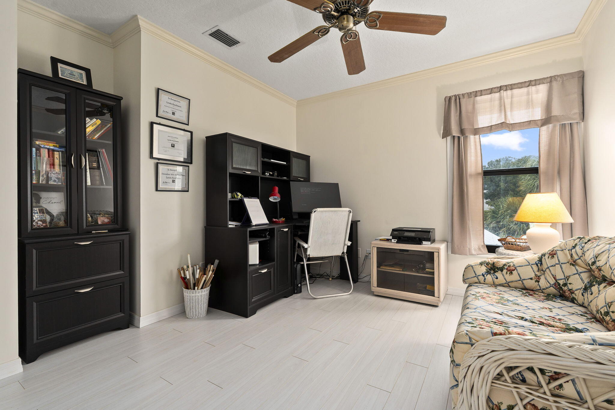 8964 Southeast Sunfish Place Hobe Sound, FL 33455 - Photo 25 of 51 a bedroom with a bed and furniture