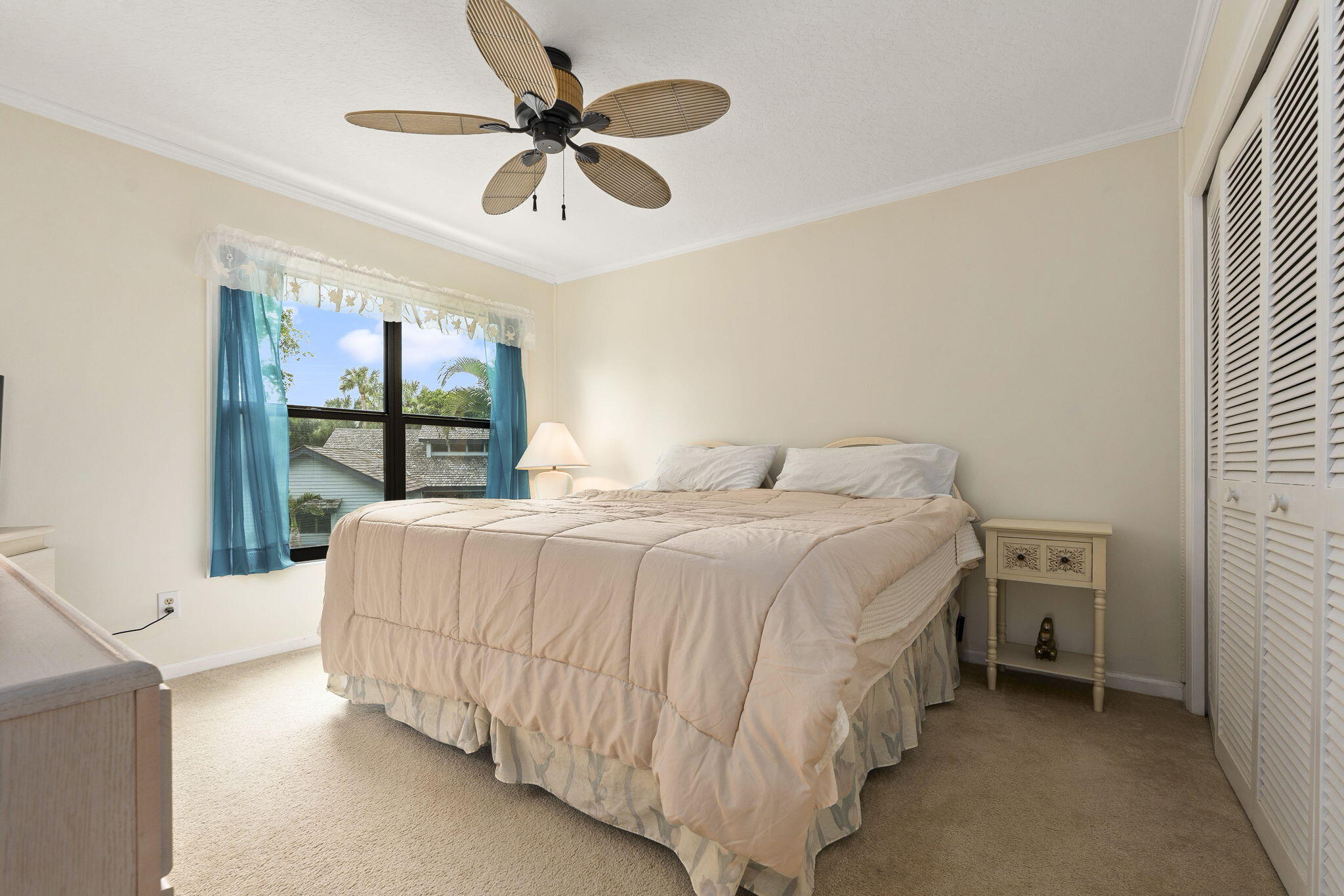 8964 Southeast Sunfish Place Hobe Sound, FL 33455 - Photo 28 of 51 a bedroom with a bed and a window