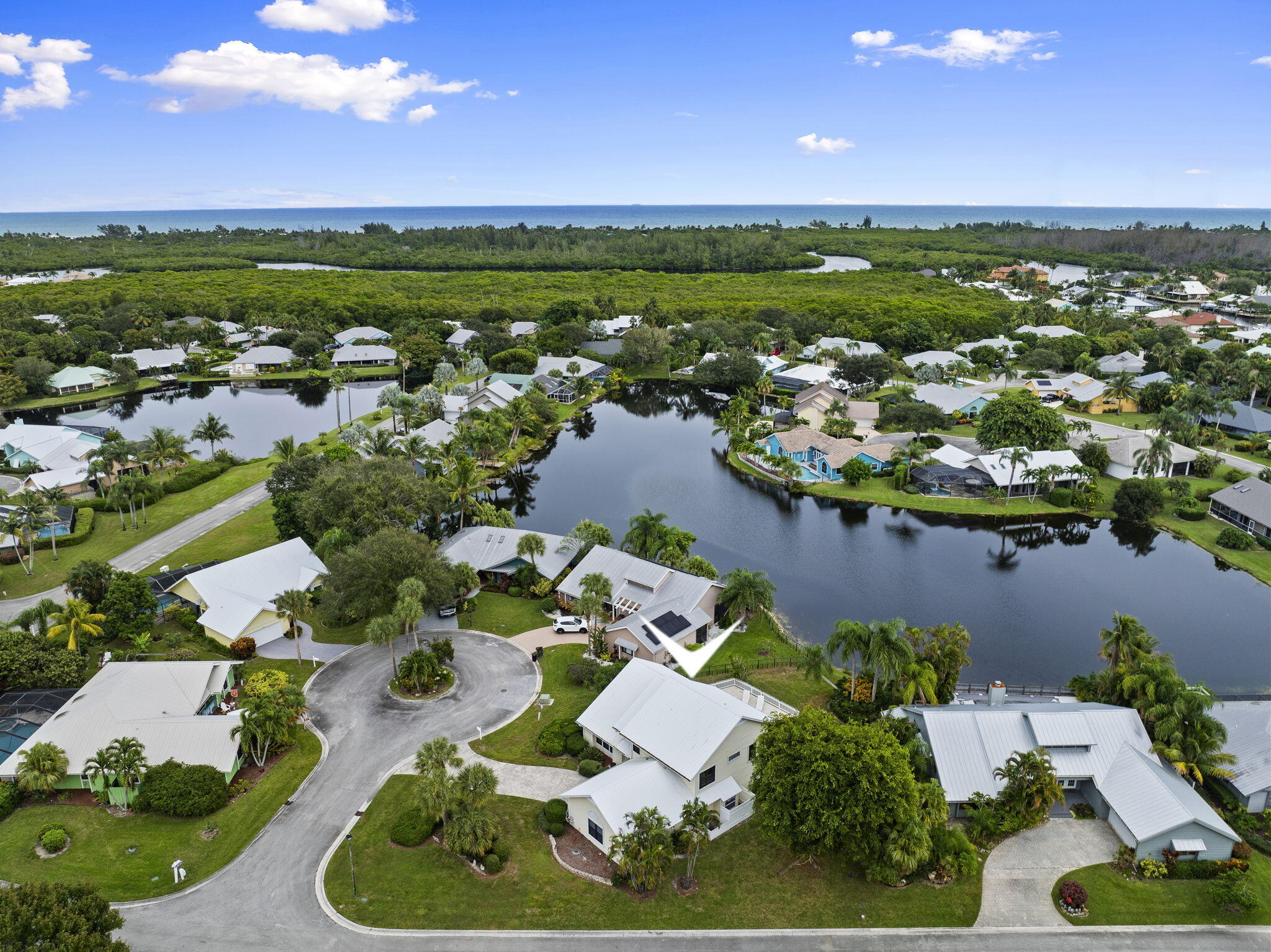 8964 Southeast Sunfish Place Hobe Sound, FL 33455 - Photo 3 of 51 an aerial view of residential houses with outdoor space