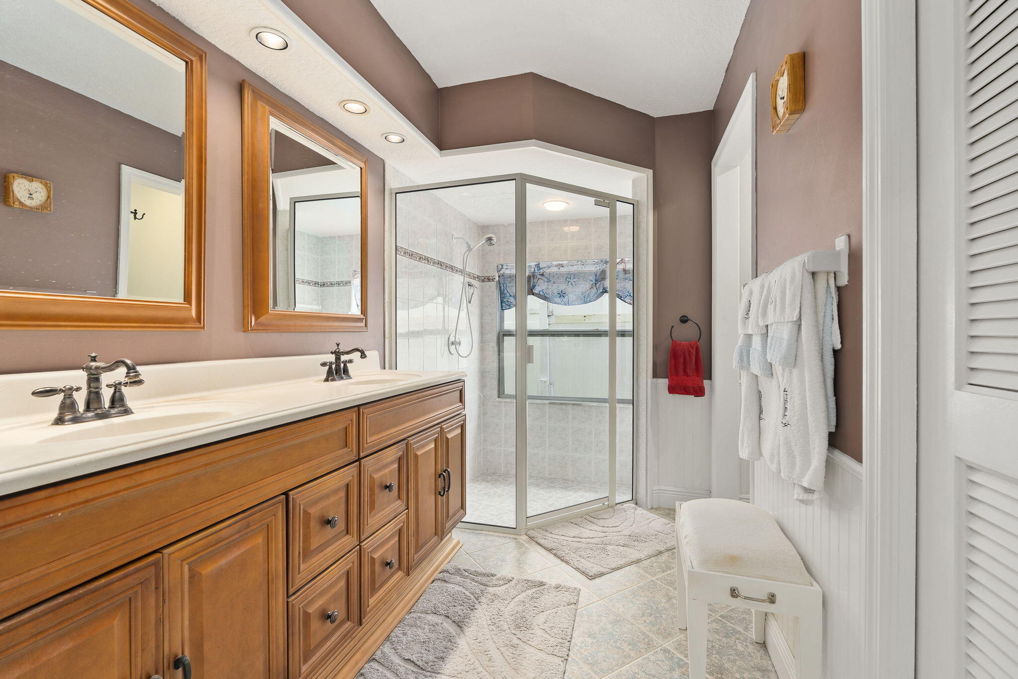 8964 Southeast Sunfish Place Hobe Sound, FL 33455 - Photo 33 of 51 a bathroom with a double vanity sink mirror and shower
