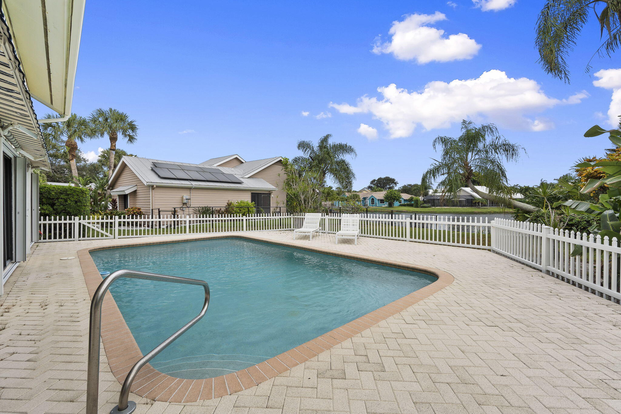 8964 Southeast Sunfish Place Hobe Sound, FL 33455 - Photo 37 of 51 a view of a swimming pool with an outdoor seating