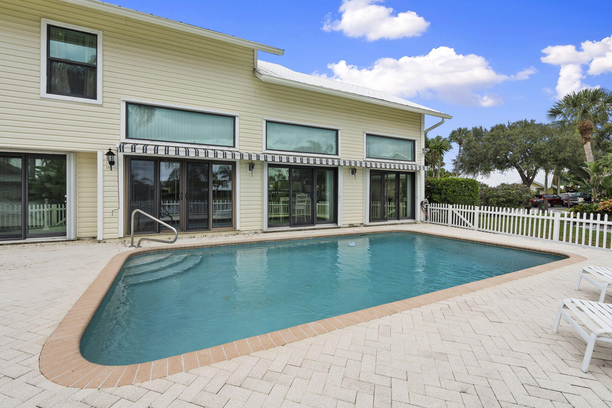 8964 Southeast Sunfish Place Hobe Sound, FL 33455 - Photo 40 of 51 a view of a house with a swimming pool