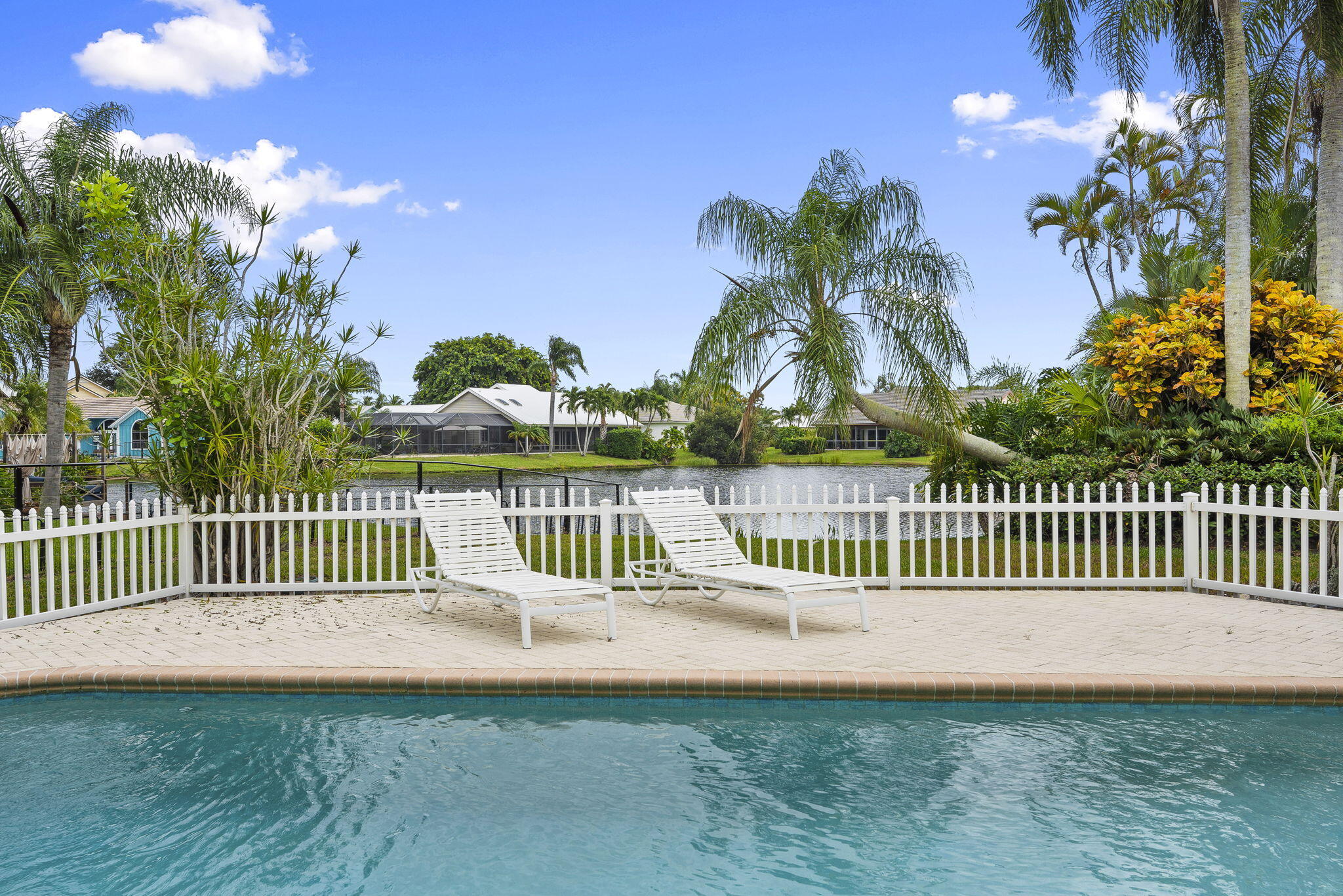 8964 Southeast Sunfish Place Hobe Sound, FL 33455 - Photo 42 of 51 a view of a deck with a garden