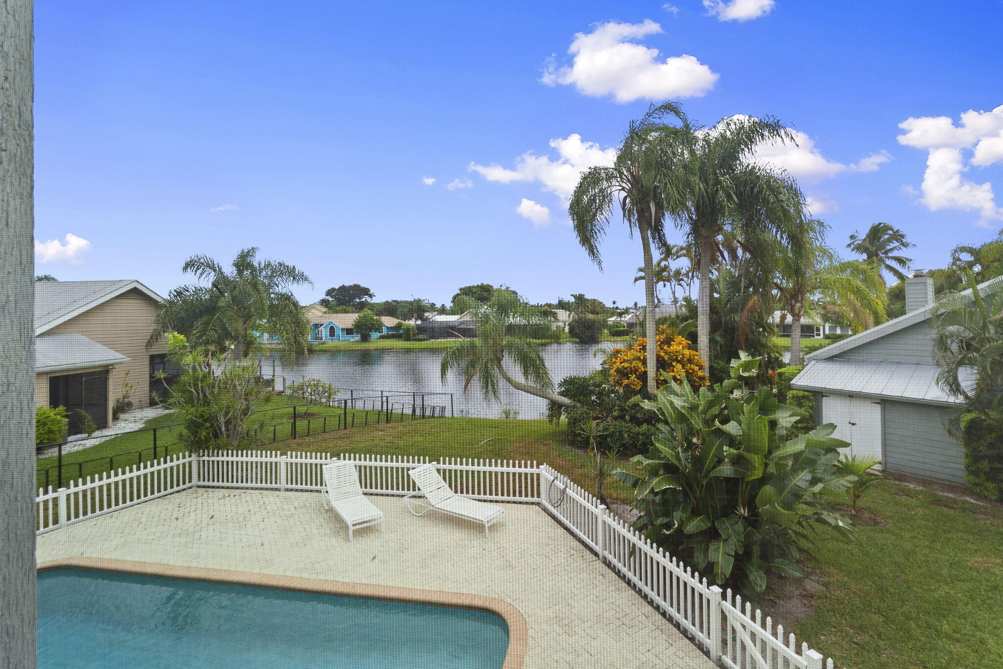 8964 Southeast Sunfish Place Hobe Sound, FL 33455 - Photo 43 of 51 a view of a swimming pool with a patio