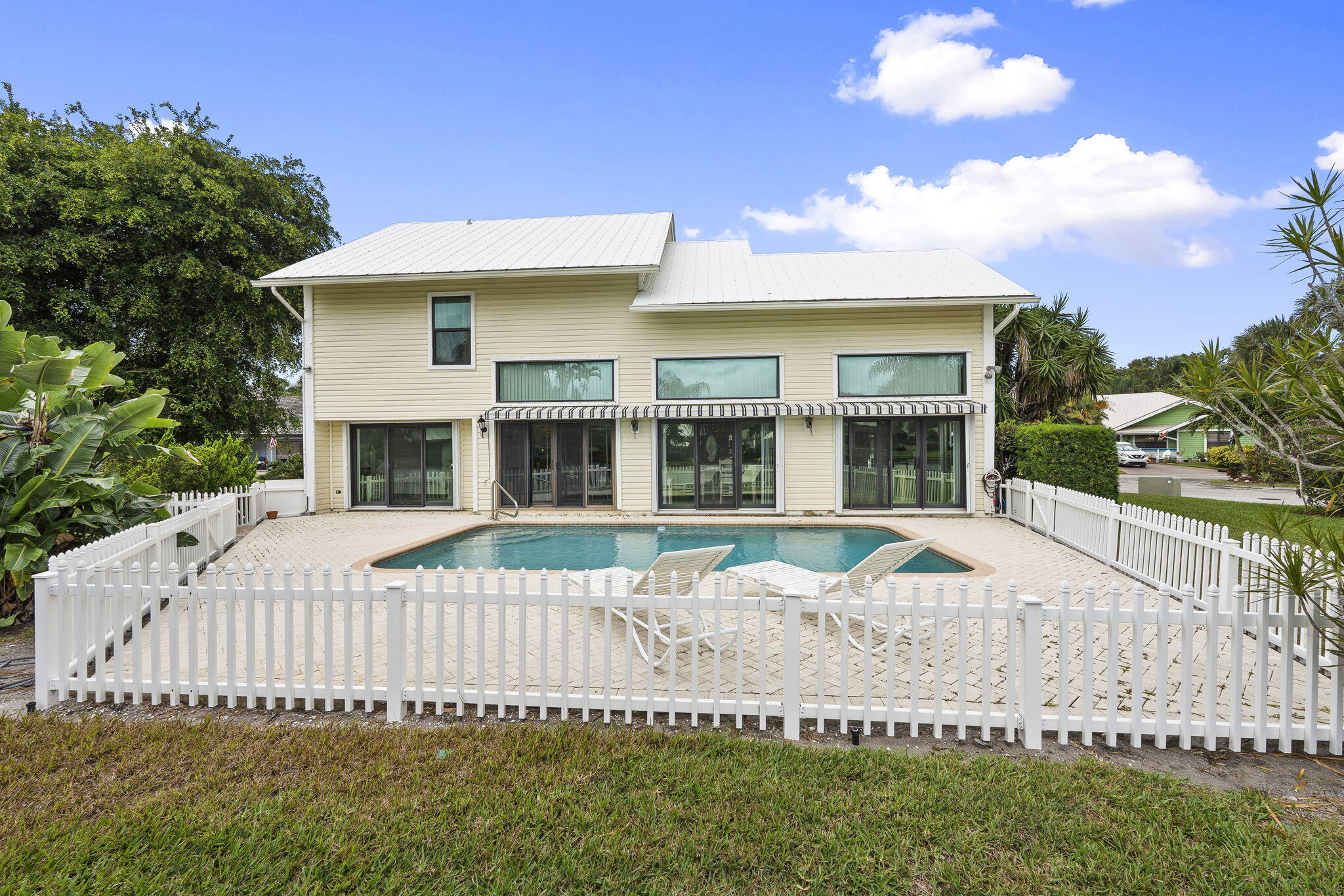 8964 Southeast Sunfish Place Hobe Sound, FL 33455 - Photo 45 of 51 a front view of a house with a yard