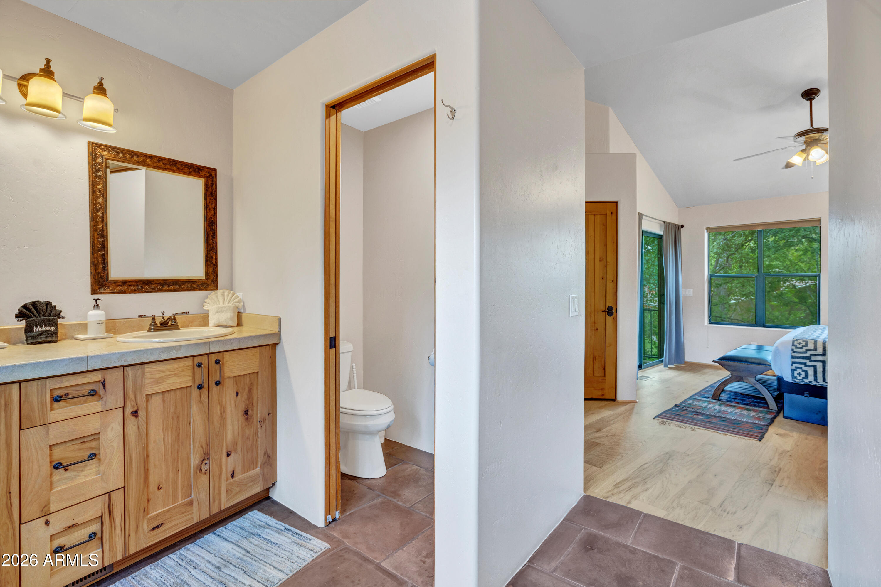 55 Ranch House Circle Sedona, AZ 86336 - Photo 52 of 61 a spacious bathroom with a toilet sink and mirror