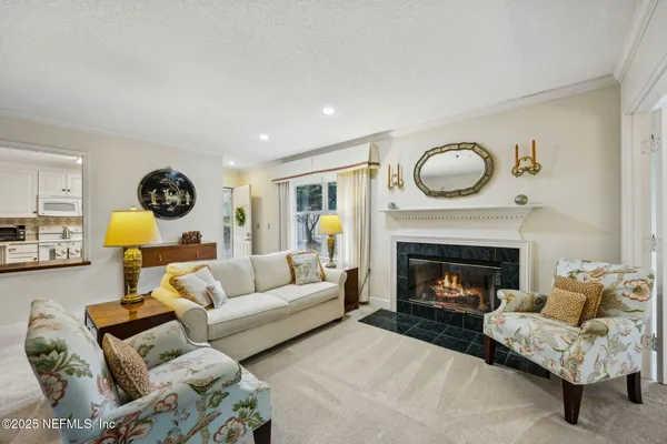 a living room with furniture a fireplace and a wall painting