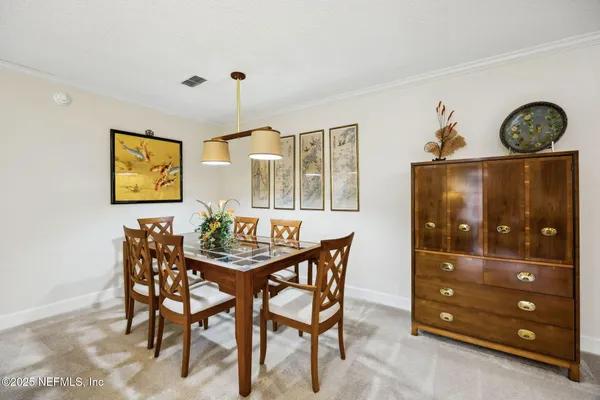 a dining room with furniture and window