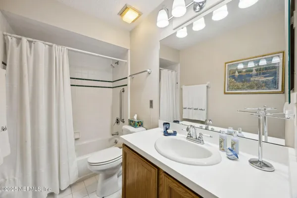 a bathroom with a sink vanity mirror and toilet