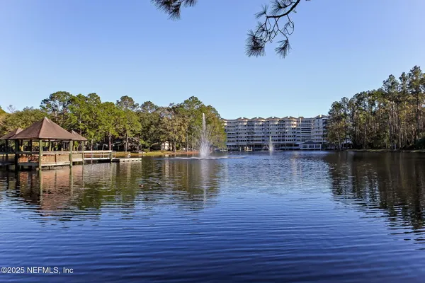an aerial view of a house with a garden and lake view
