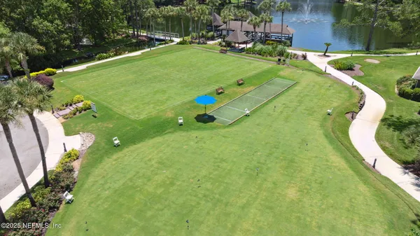 a swimming pool with lots of tress and trees in the background