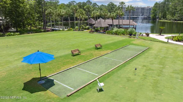 a view of swimming pool with large trees