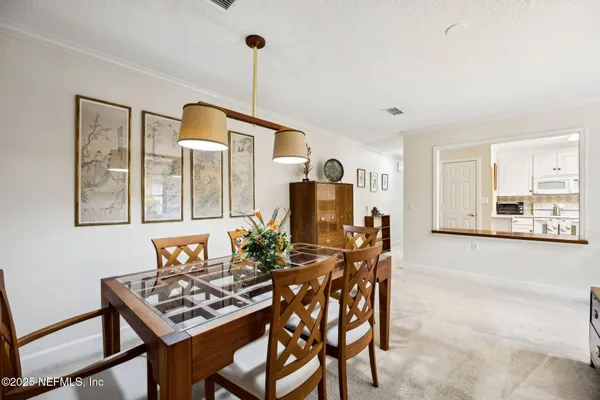 a dining room with furniture and window