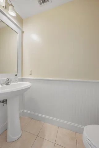 a bathroom with a sink a toilet and vanity