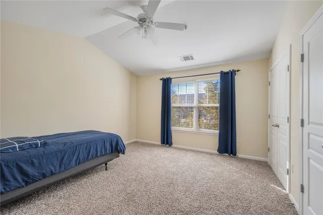 a living room with a bed furniture and a large window