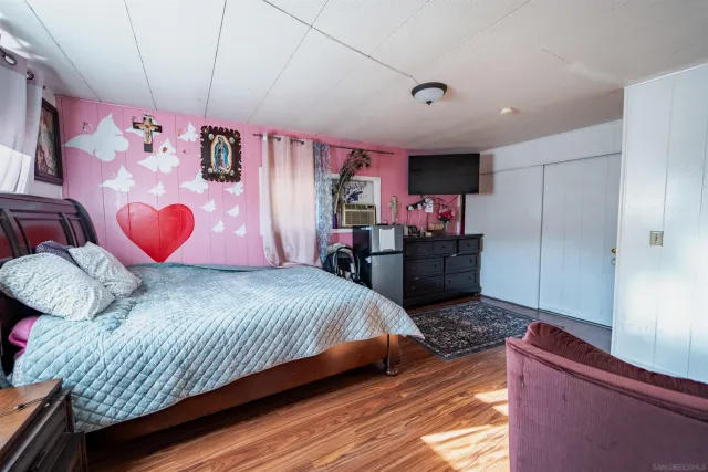 a bedroom with a bed and dresser