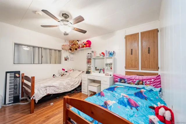 a playing room with furniture and wooden floor