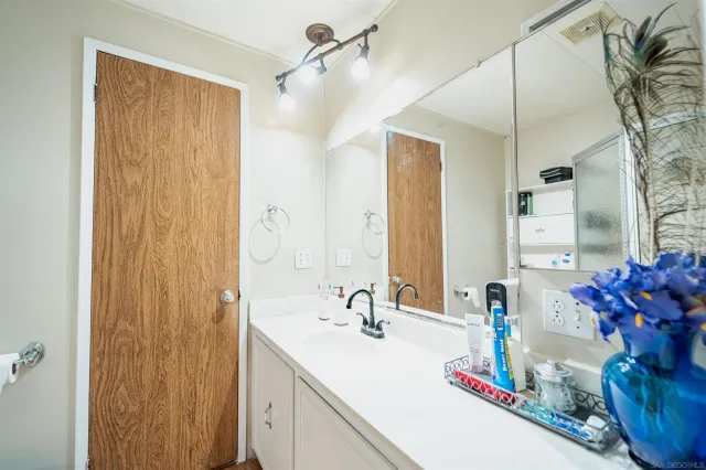 a bathroom with a double vanity sink and a mirror