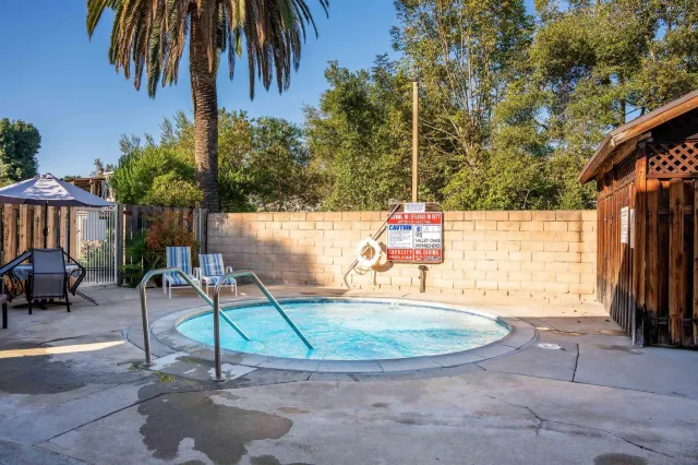 a view of a swimming pool with a chair and tables