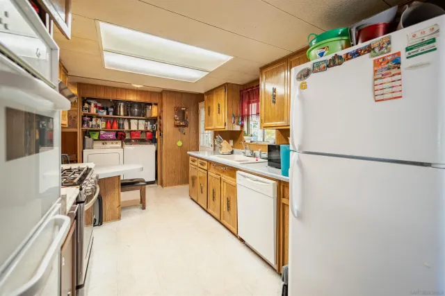 a kitchen with stainless steel appliances a refrigerator and a stove top oven