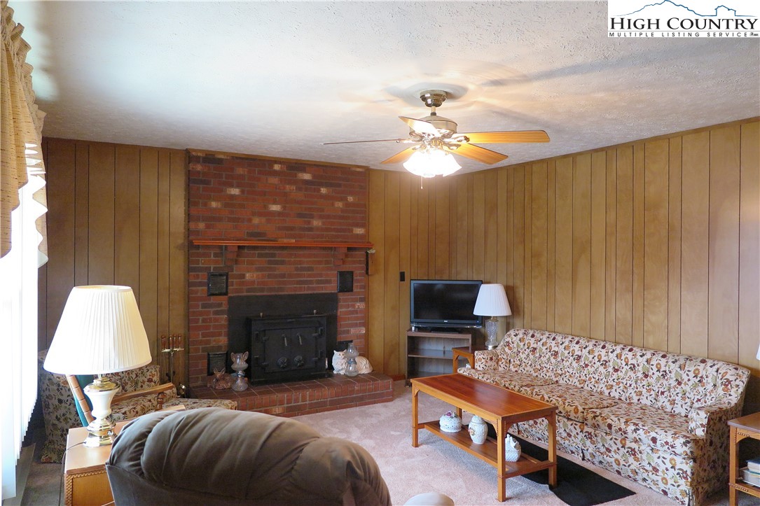 134 Carson Boulevard Sparta, NC 28675 - Photo 2 of 15 a living room with furniture and a fireplace