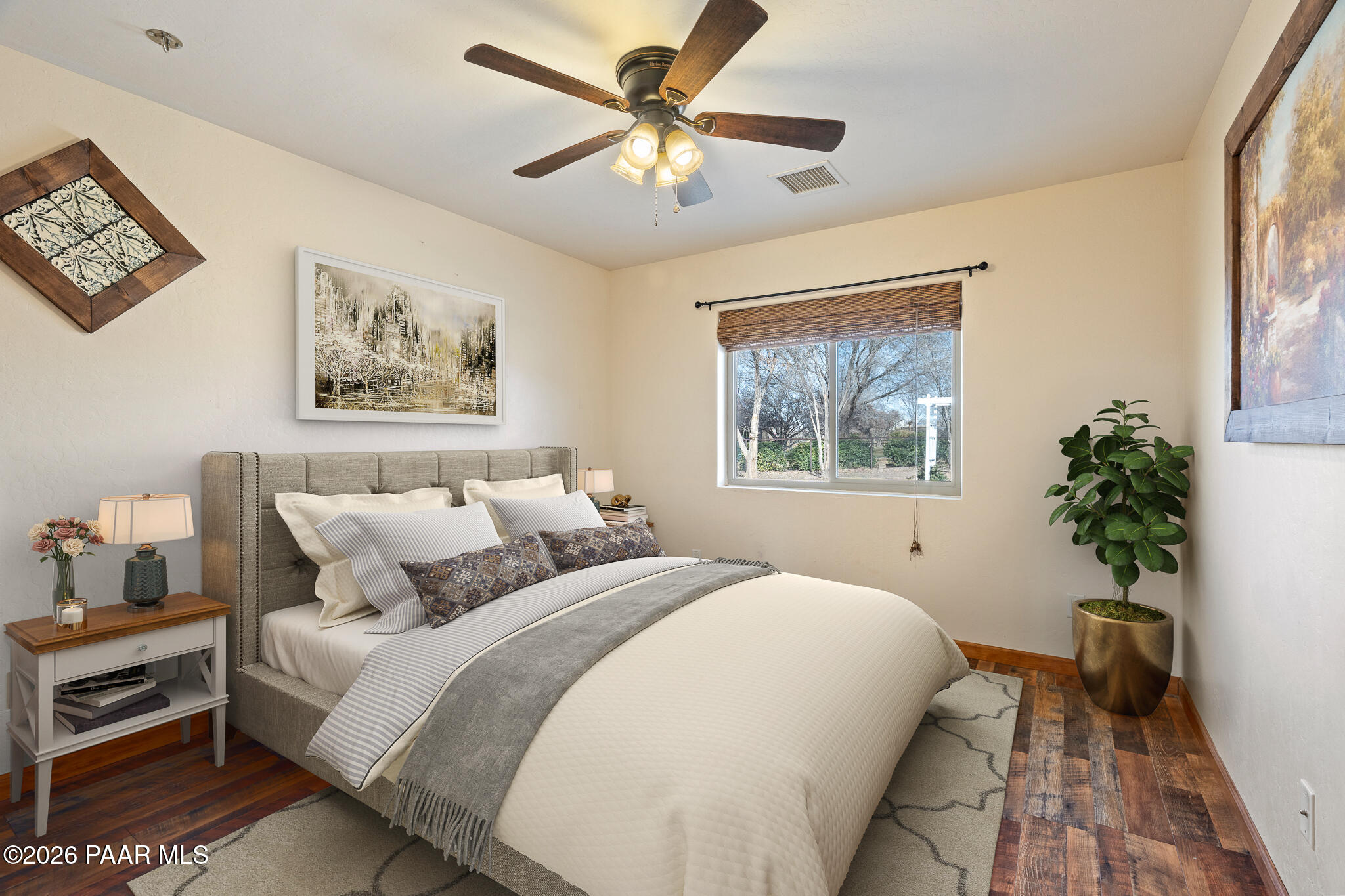 25820 Merlot Lane Paulden, AZ 86334 - Photo 25 of 55 a bedroom with bed painting on the wall and a potted plant
