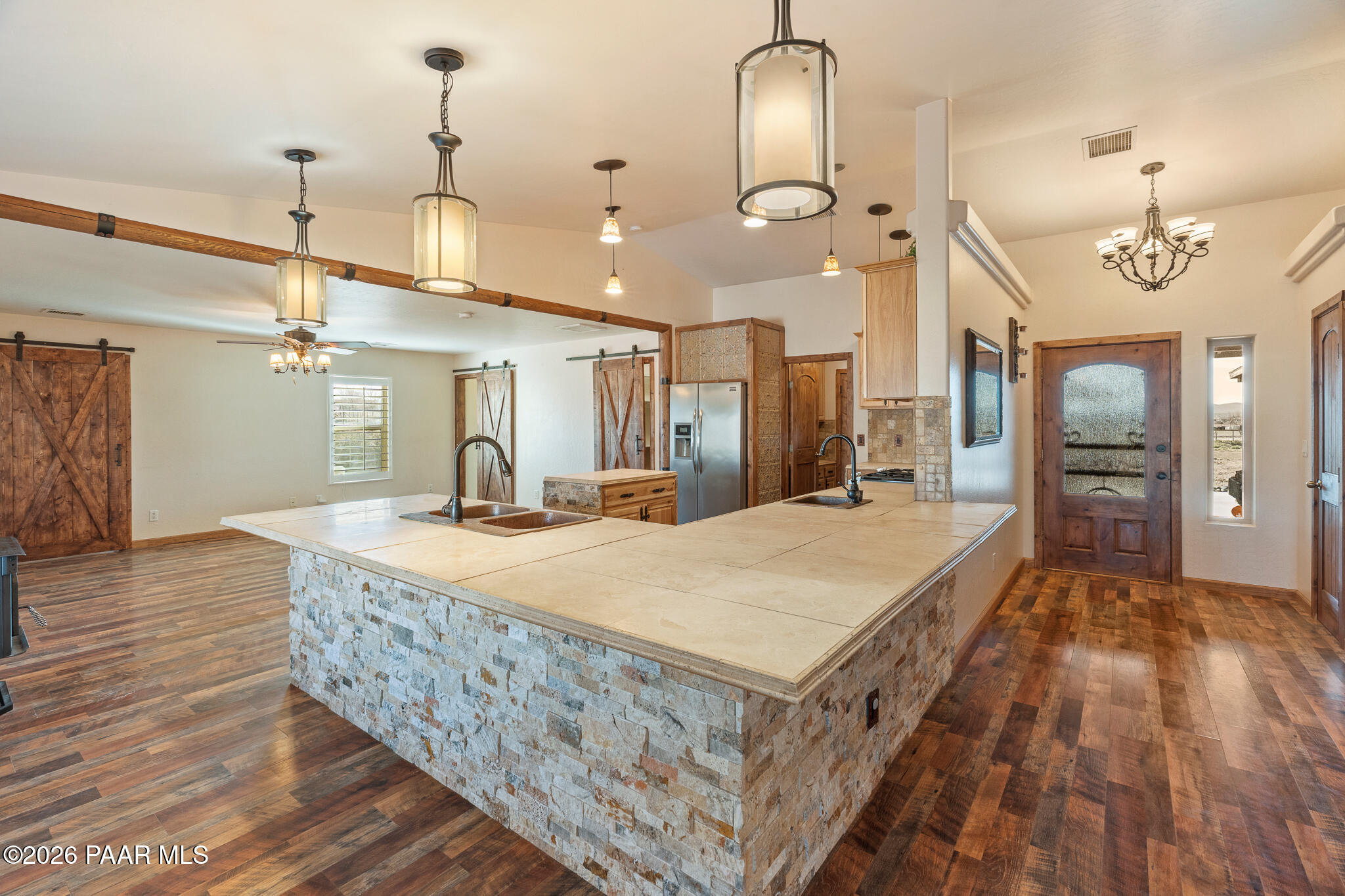25820 Merlot Lane Paulden, AZ 86334 - Photo 6 of 55 a large kitchen with kitchen island a stove a sink a refrigerator and a wooden floor