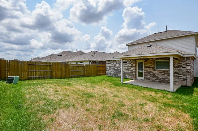 a view of a couches in front of house with a yard