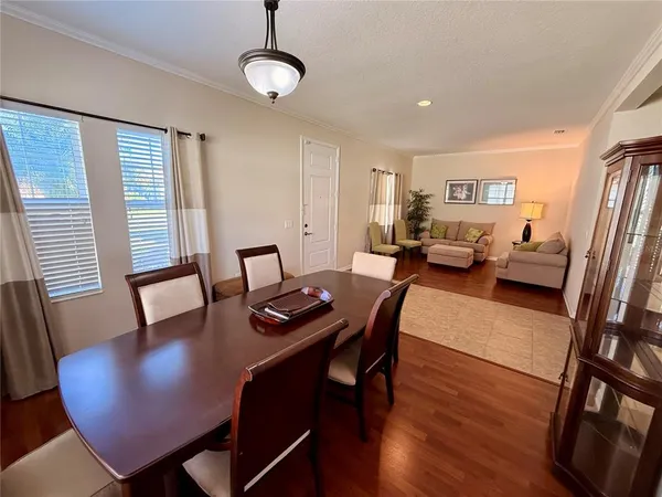 a view of a dining room with furniture and wooden floor