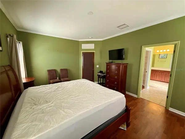 a bedroom with a bed and a flat screen tv