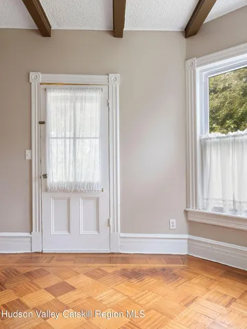 a view of an entryway with wooden floor