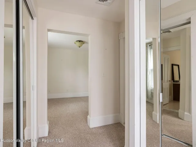 a aerial view of a house with a small yard and large trees