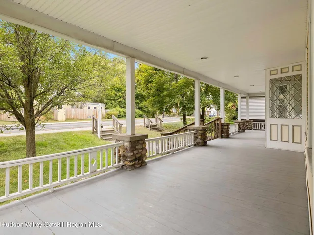 a view of a livingroom with a dinning area and chandelier