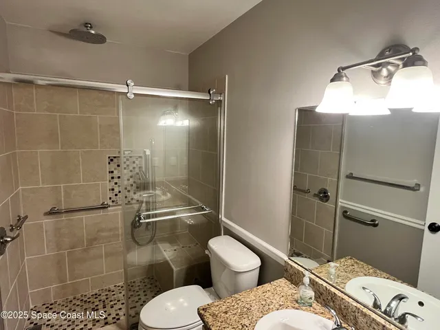 a bathroom with a toilet and a shower