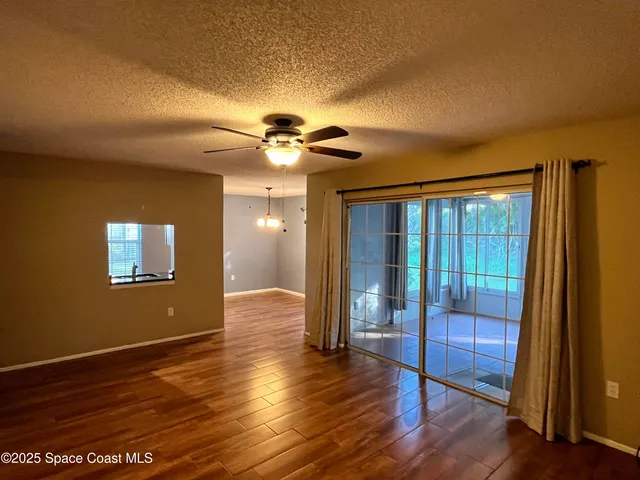 a view of livingroom with hardwood floor and ceiling fan