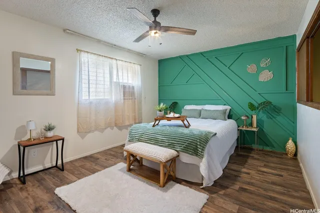 a bed sitting in a spacious bedroom next to a window