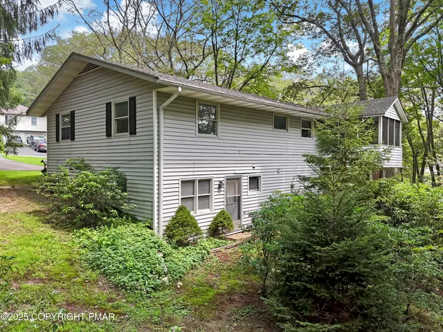 a view of a house with a yard and plants