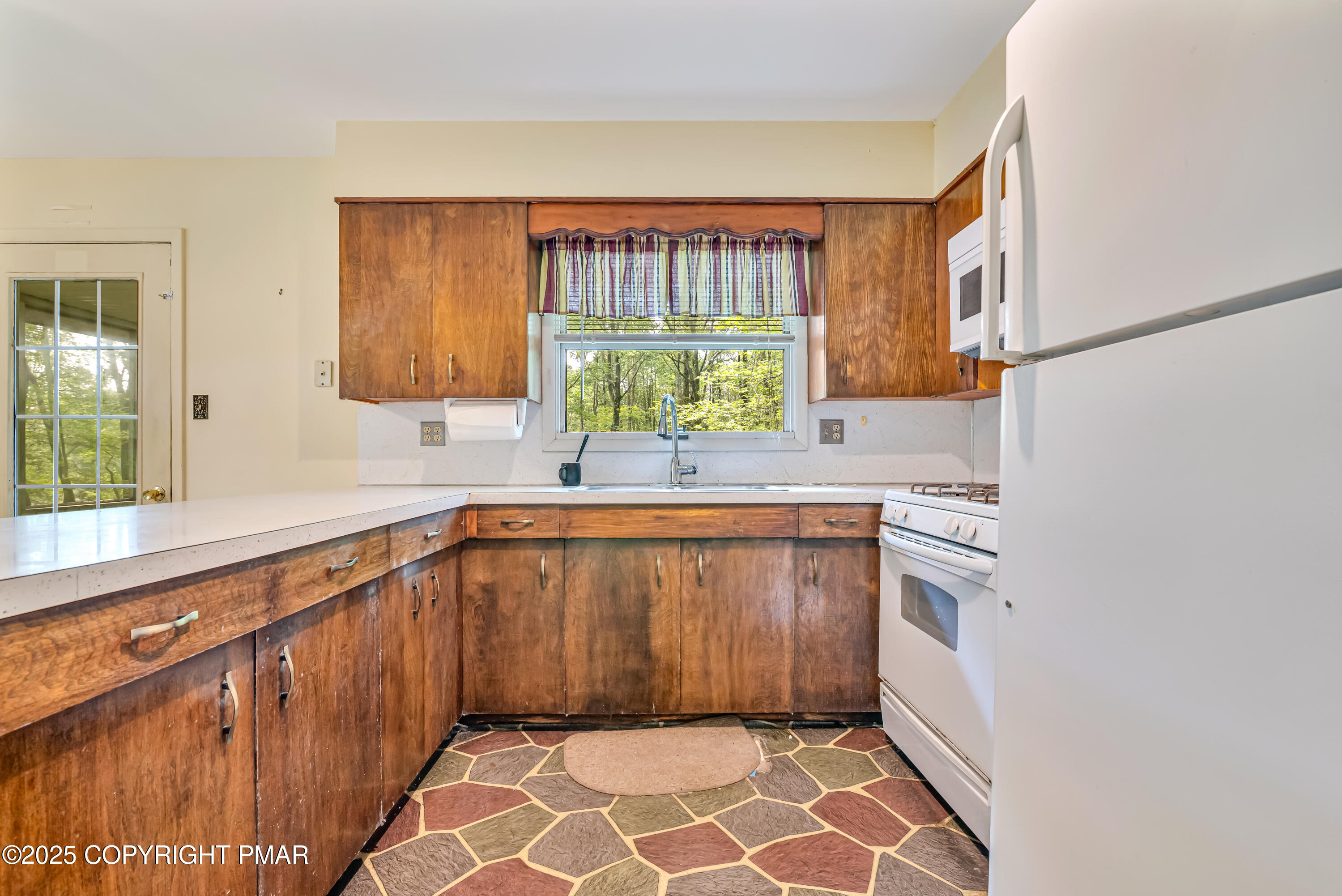 129 Winona Road Mount Pocono, PA 18344 - Photo 18 of 64 a kitchen with a sink a window and cabinets