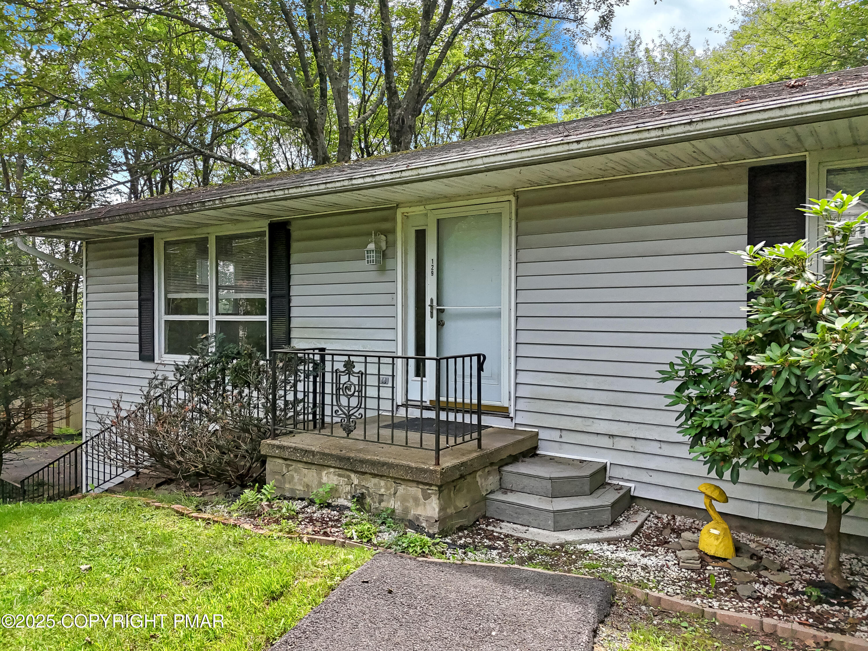 129 Winona Road Mount Pocono, PA 18344 - Photo 2 of 64 a front view of a house with garden