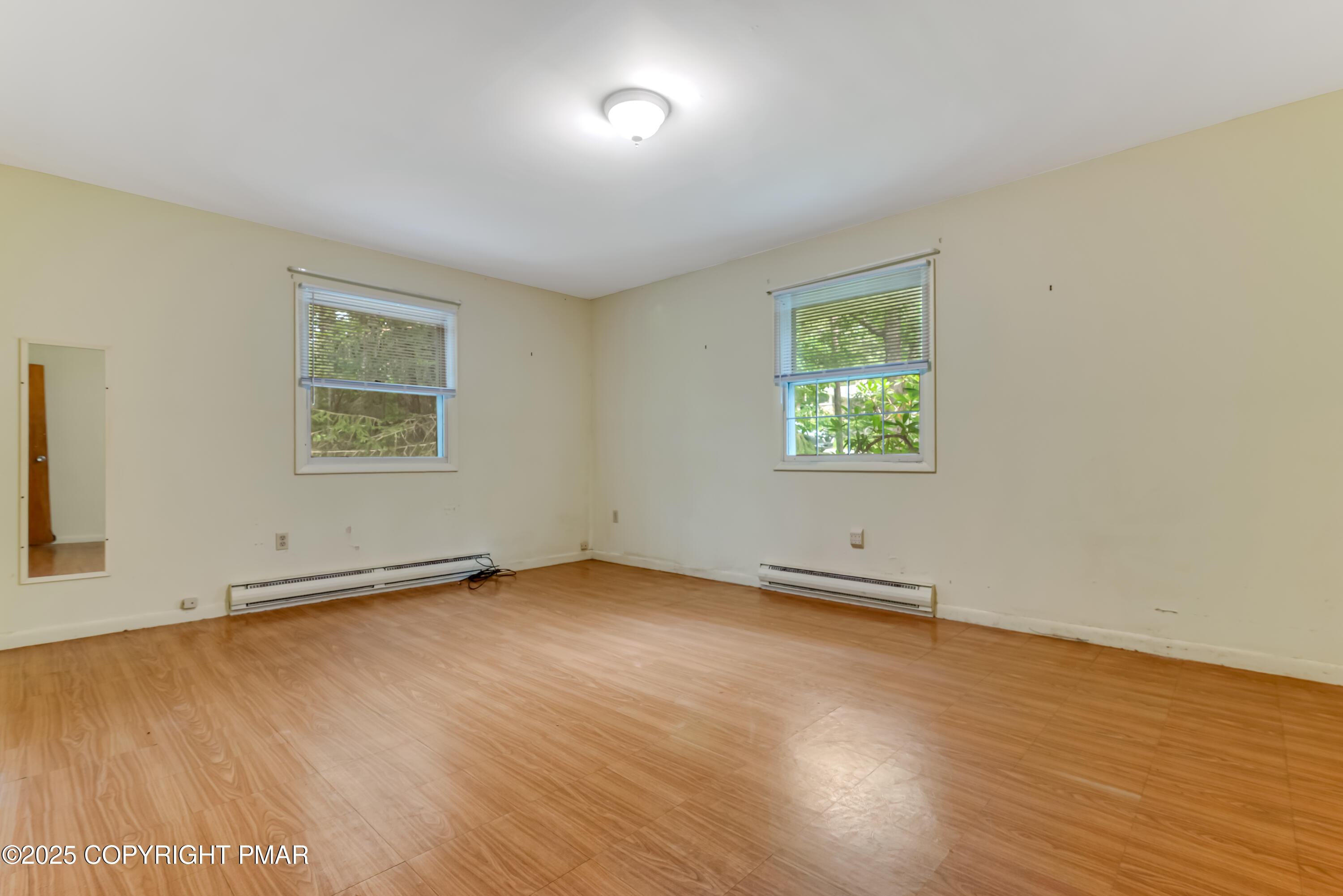 129 Winona Road Mount Pocono, PA 18344 - Photo 27 of 64 an empty room with wooden floor and windows