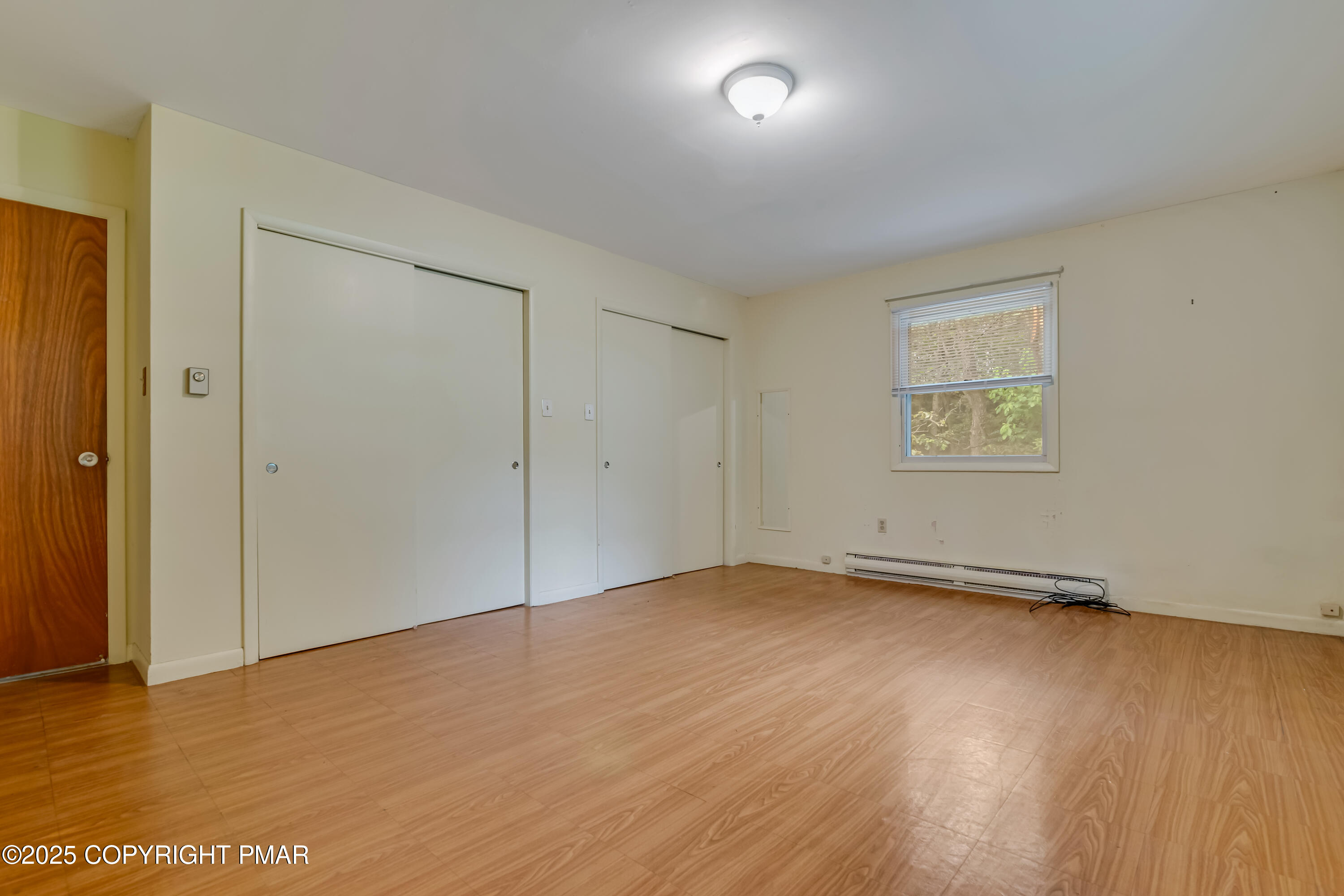 129 Winona Road Mount Pocono, PA 18344 - Photo 29 of 64 an empty room with wooden floor and windows