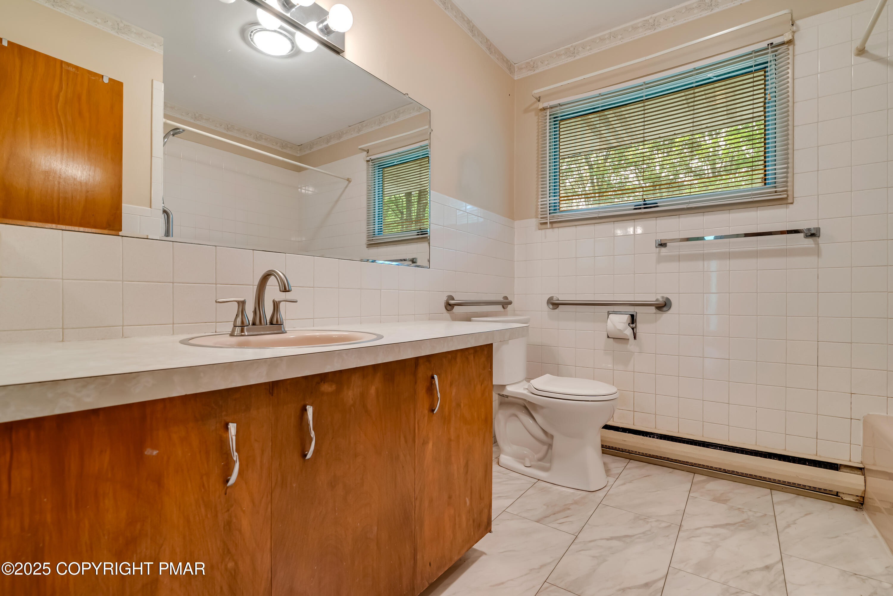 129 Winona Road Mount Pocono, PA 18344 - Photo 31 of 64 a bathroom with a toilet sink and mirror