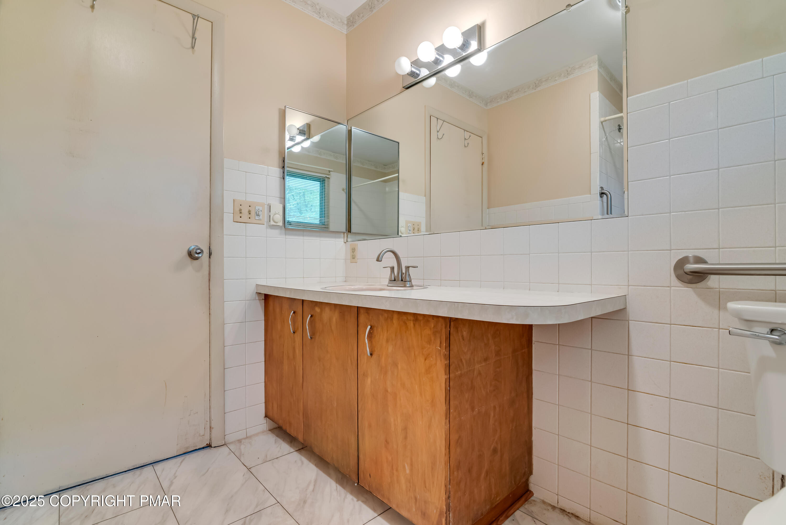 129 Winona Road Mount Pocono, PA 18344 - Photo 33 of 64 a bathroom with a sink and a mirror